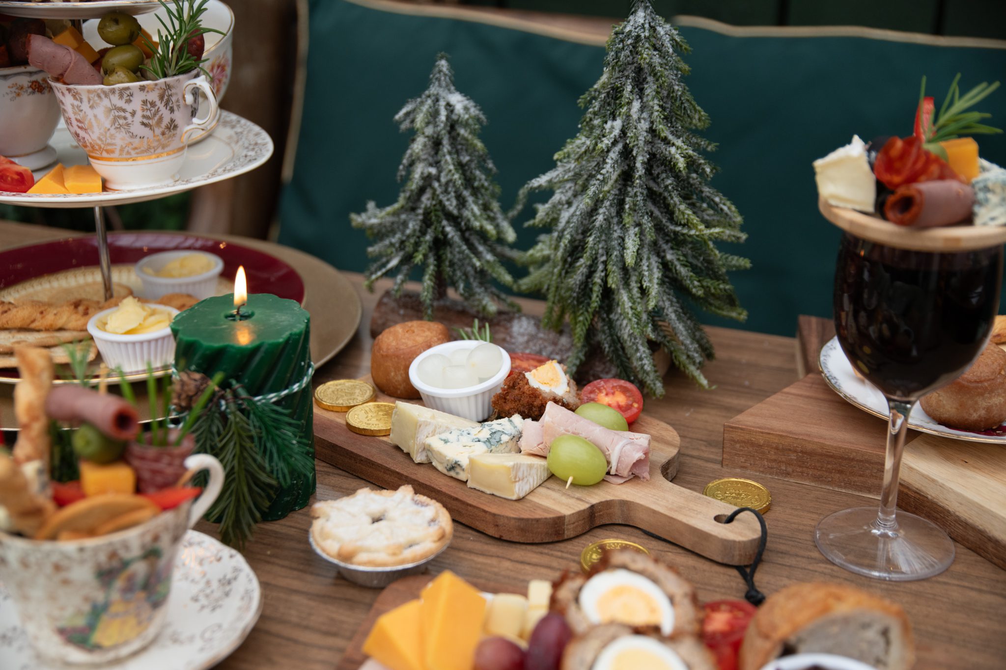 A festive scene at Bondville Model Village with twinkling lights, a large Christmas tree, and decorated miniature houses for the holiday season.
