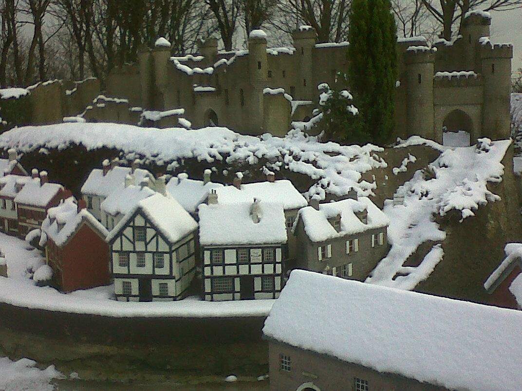 Scenic view of Bondville Model Village in autumn, showcasing intricate miniature buildings and pathways.